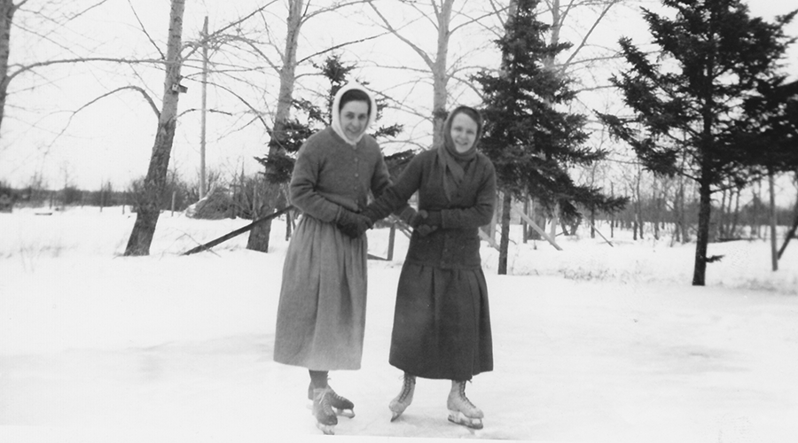 Sisters skate on outdoor pond