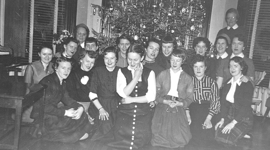Sisters and residents in front of Christmas tree